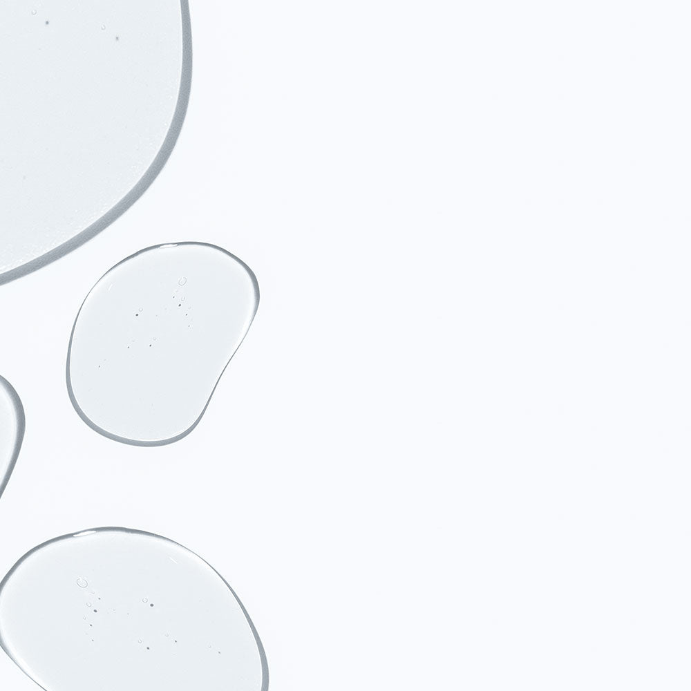 Translucent water droplets on a light gray background