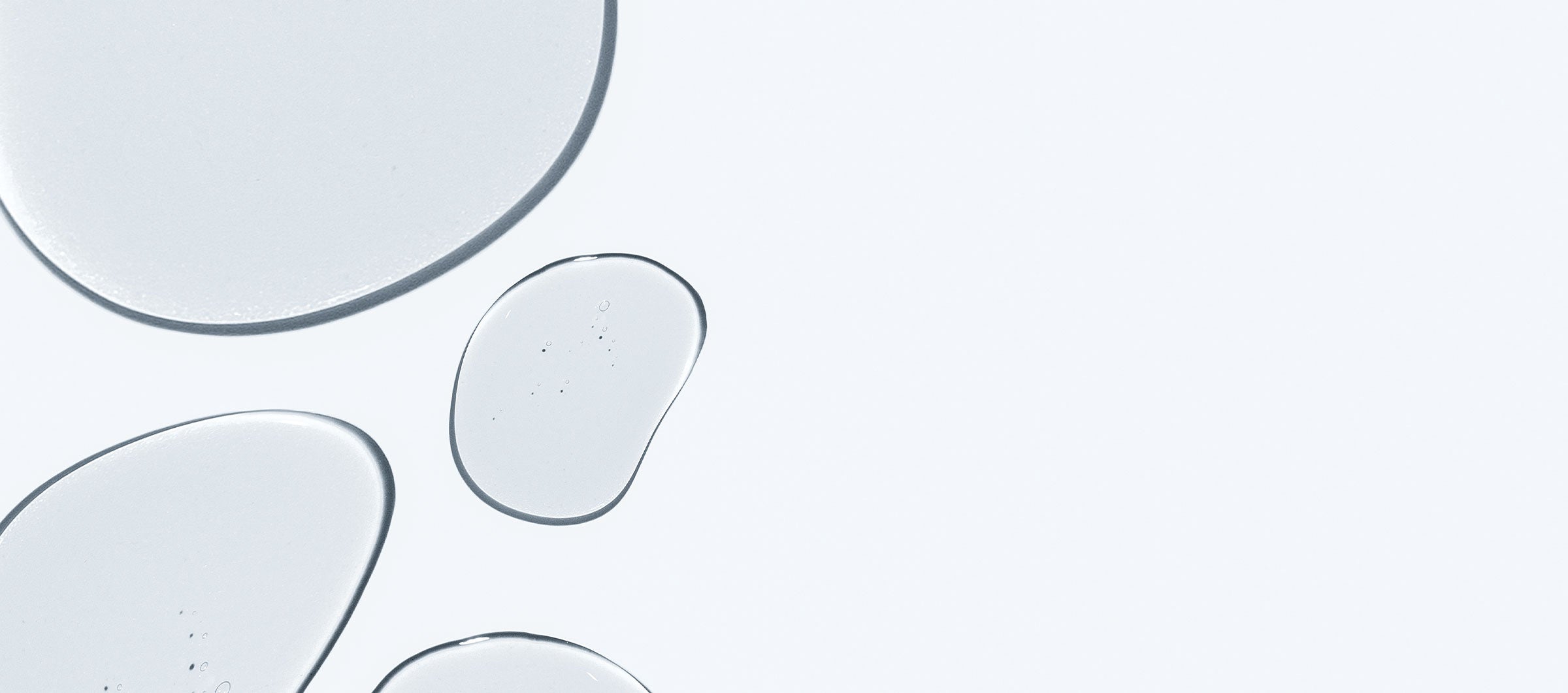 Translucent water droplets on a light gray background